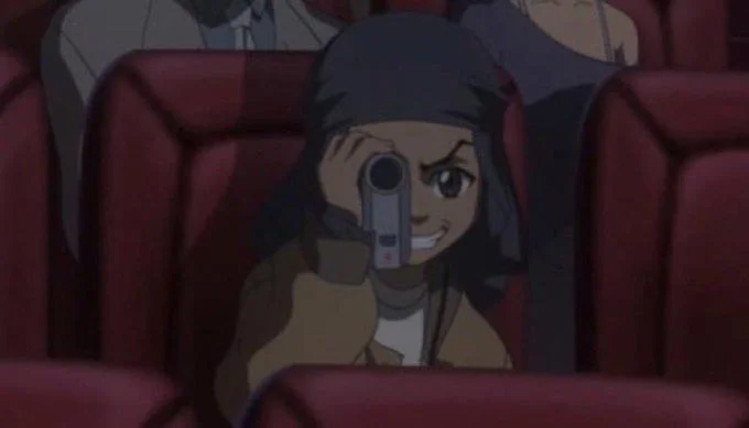 Caught In 4K — Anime character with camera-like equipment in theater setting