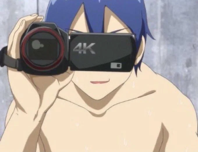Caught In 4K — Anime character with professional 4K filming equipment and label