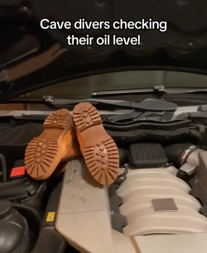 Cave Diver Memes — Boots placed upside-down on a car engine with caption Cave divers checking their oil level