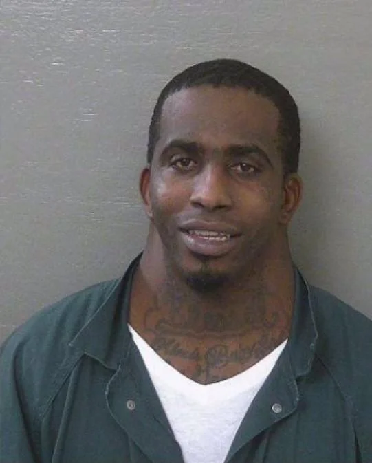 Charles Mcdowells Wide Neck Mugshot — Full mugshot of Charles Dion McDowell in green jail uniform with visible wide neck