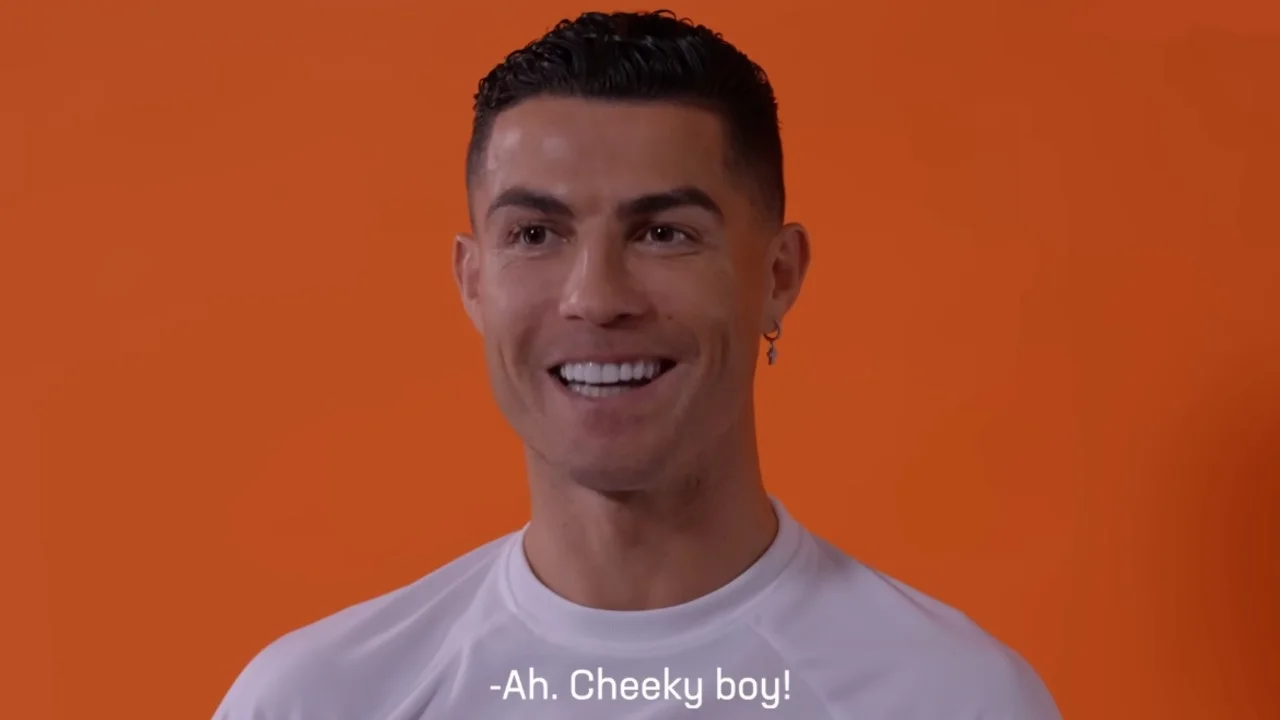 "Cheeky Boy" Ronaldo — Cristiano Ronaldo smiling in front of an orange background with the subtitle 'Ah. Cheeky boy!'