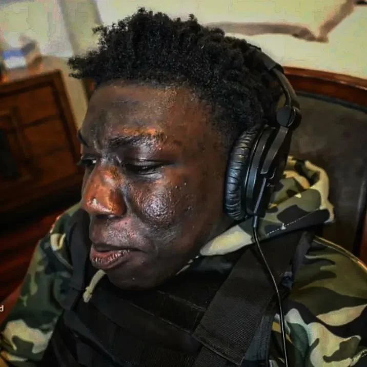 Chopped Slang — Distressed-looking man in headphones and camo jacket