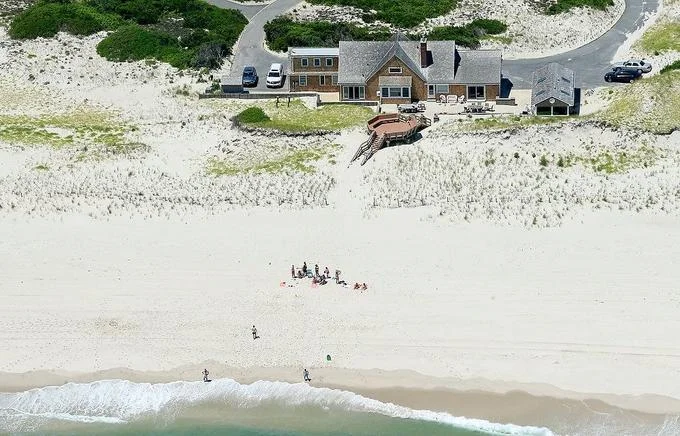 Chris Christie Beach Picture — Aerial view of the governor's beach house at Island Beach State Park with a few people on the empty sand.