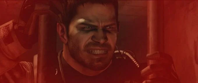 Chris Redfield displaying angry determined expression in red dramatic lighting.