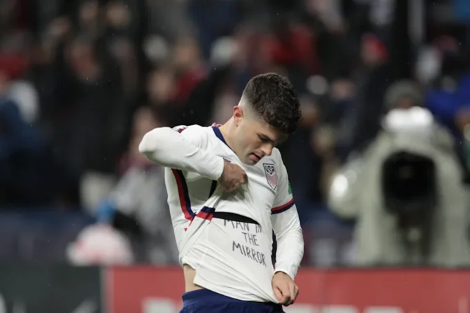 Christian Pulisics Its Called Soccer Shirt — Edited Pulisic photo with undershirt reading 'Man in the Mirror'