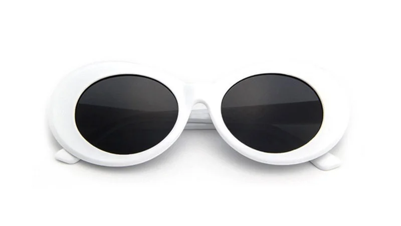 White oval-framed sunglasses with dark lenses known as Clout Goggles