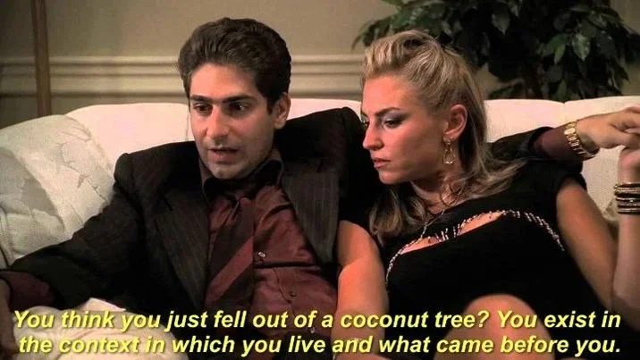 TV scene showing characters discussing coconut tree and philosophical context