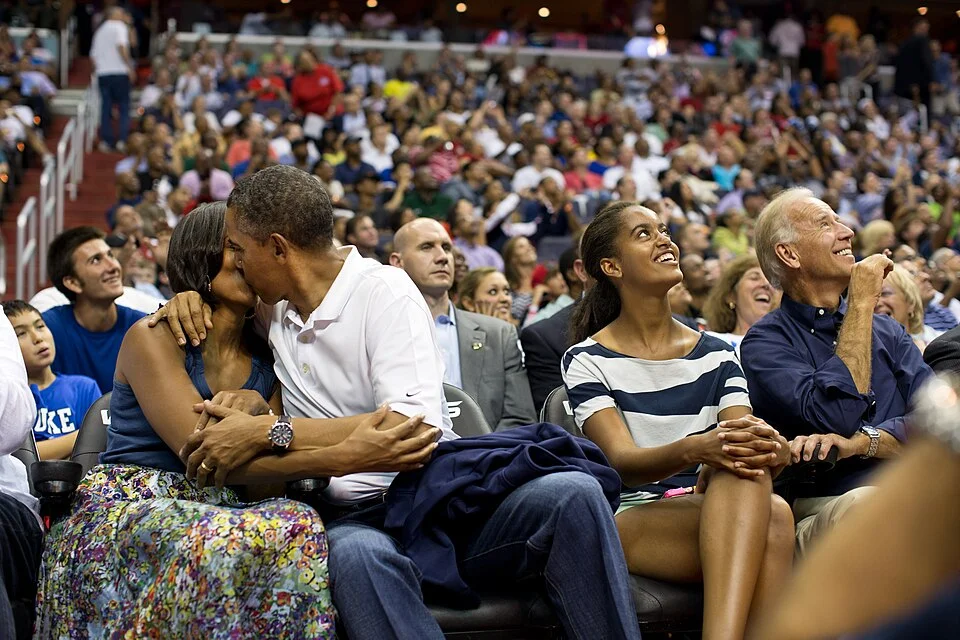 Coldplay Couple — Candid photograph of couple sitting together at crowded venue or event.