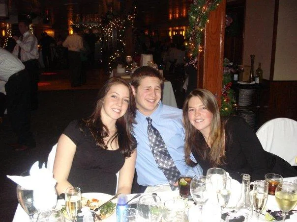 College Freshman — Three young people posed at a dinner table with wine glasses and holiday decorations