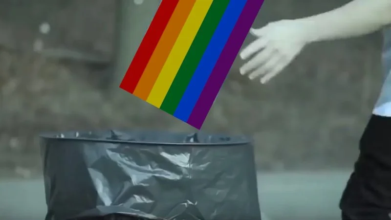 Companies When Pride Month Ends — Hand releasing pride flag into black trash bag.