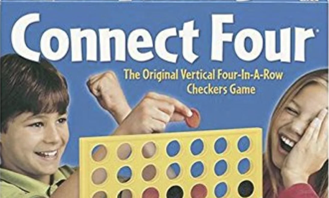 Cropped Connect Four board game box showing a boy and girl playing, with the game logo