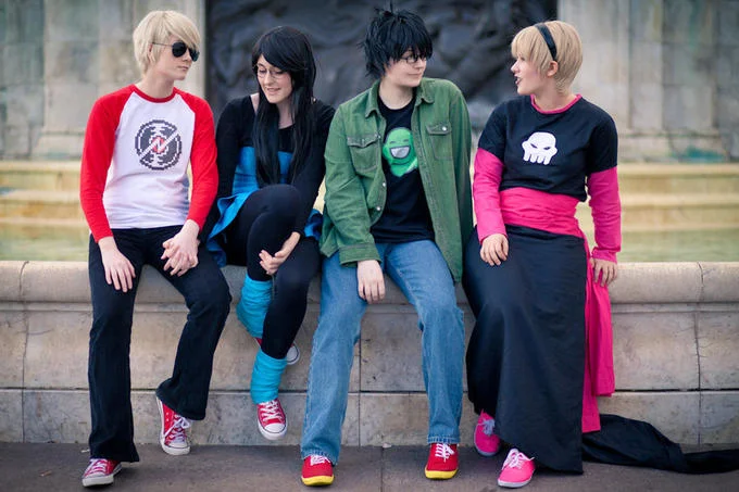 Group of Star Trek cosplayers in colored Starfleet uniforms at a convention