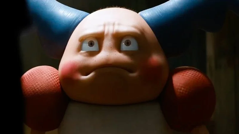 Creepy Mr Mime — Close-up portrait of 3D-rendered Mr. Mime from Detective Pikachu showing pale face with large eyes, red cheeks, and red boxing gloves.