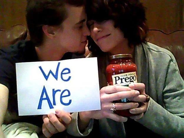 Couple holding We Are sign and Prego sauce jar in a cringeworthy pregnancy announcement
