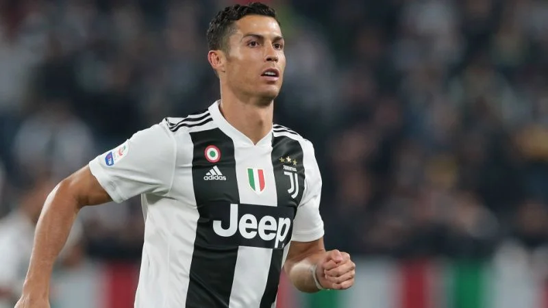 Cristiano Ronaldo running in a black and white Juventus jersey during a match