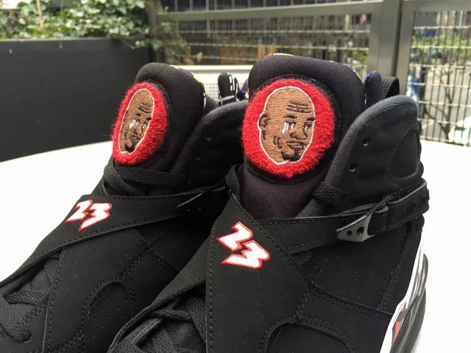 Crying Jordan — Air Jordan high-top sneakers customized with Michael Jordan's crying face photoshopped onto both shoe tongues.