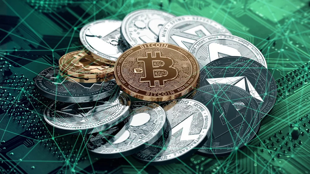 Cryptocurrency — Pile of physical Bitcoin and altcoin tokens on a green circuit board background