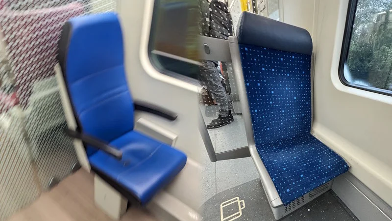 Cuckstoel — Photograph of blue transit seats inside Dutch train or bus showing distinctive backward-facing configuration.