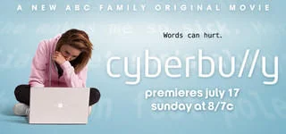 Cyberbullying — ABC Family 'Cyberbully' movie promotional banner with teenage girl hunched over laptop looking distressed.