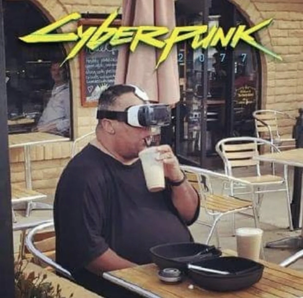 Meme showing someone wearing VR/AR goggles while dining at outdoor café exemplifying cyberpunk aesthetic.
