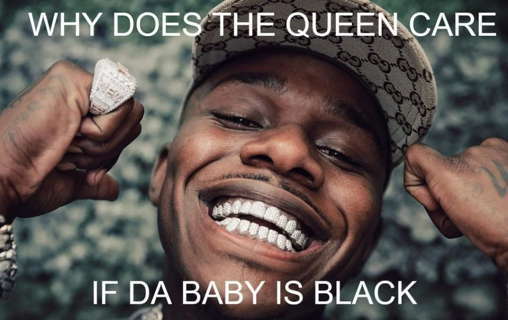 DaBaby wearing Gucci cap with styled jewelry and text 'WHY DOES THE QUEEN CARE / IF DA BABY IS BLACK'.