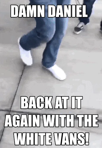 Close-up of white Vans sneakers with text 'DAMN DANIEL' and 'BACK AT IT AGAIN WITH THE WHITE VANS!'