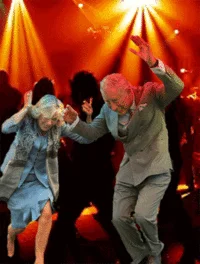 Dancing Prince Charles — Image of dancers at concert or nightclub event with dramatic red and orange stage lighting background.