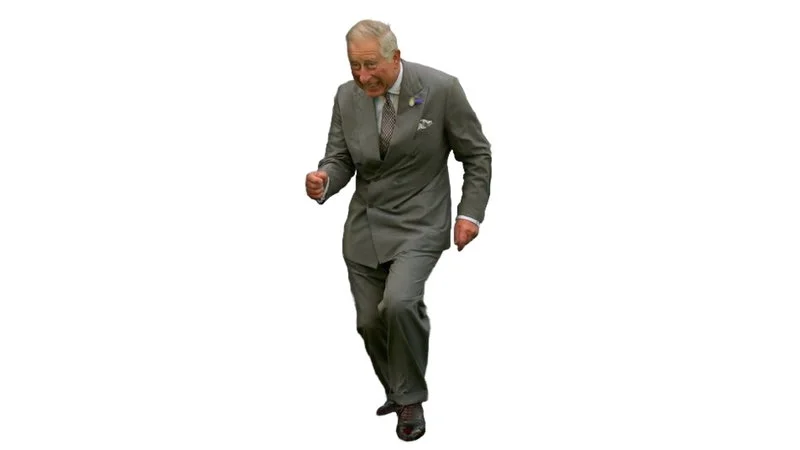 Dancing Prince Charles — Professional cutout of King Charles III in gray suit mid-dance with dynamic arm and leg positioning on white background.