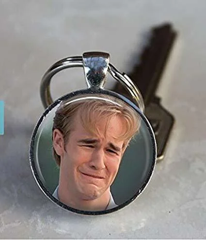 Round keychain featuring the Dawson crying photo next to a house key