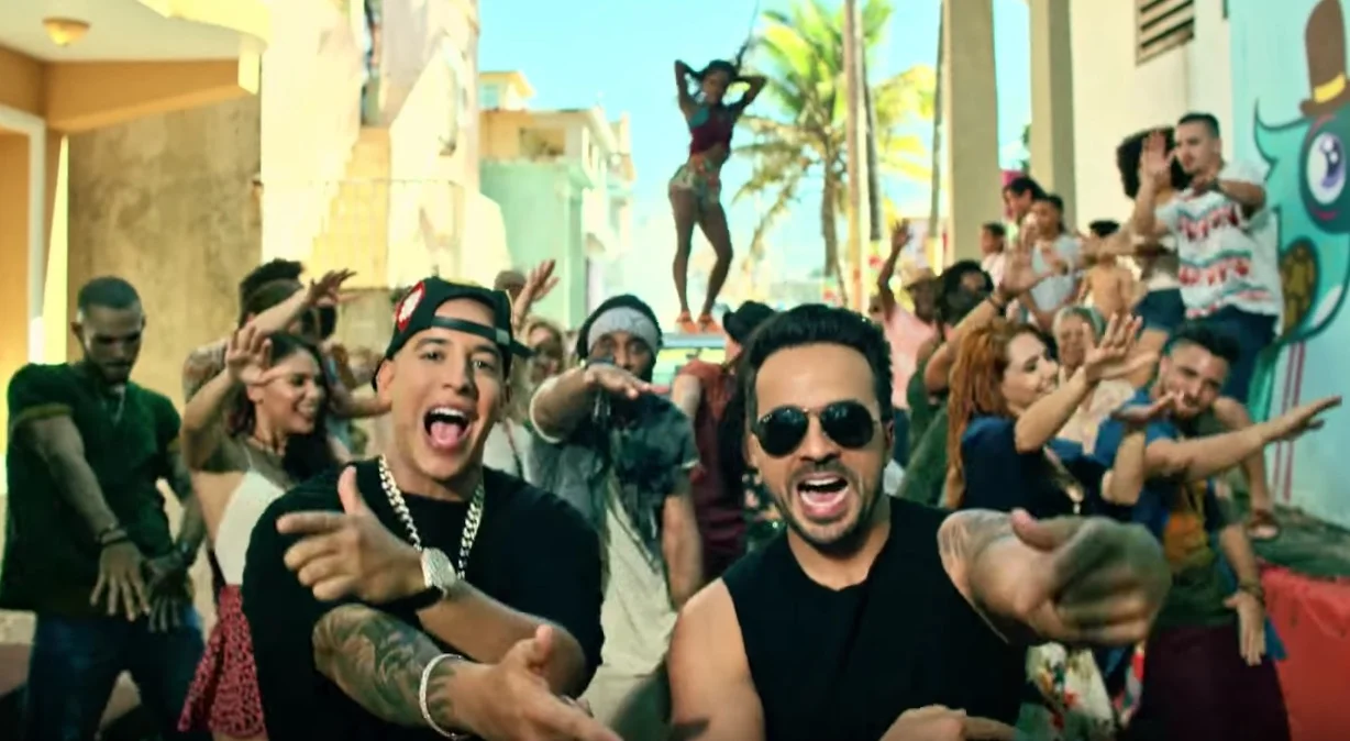 Luis Fonsi and Daddy Yankee performing in the Despacito music video with dancers behind them