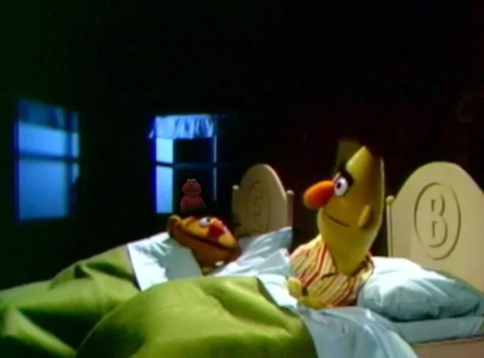 Devastated Elmo — Bert and Ernie in bed with a tiny sad Elmo standing between them