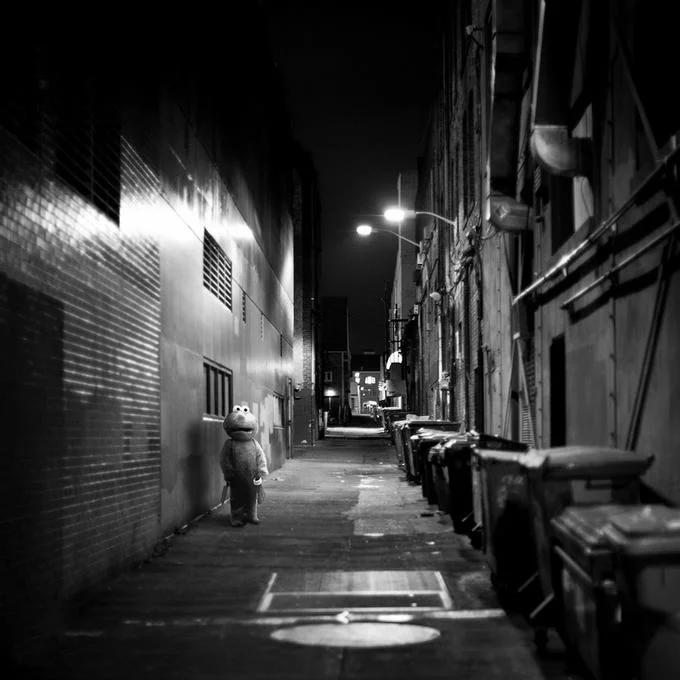 Devastated Elmo — Black-and-white photoshop of sad Elmo standing alone in a dark alleyway