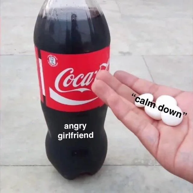 Diet Coke And Mentos — Coca-Cola bottle labeled angry girlfriend beside hand holding Mentos labeled calm down