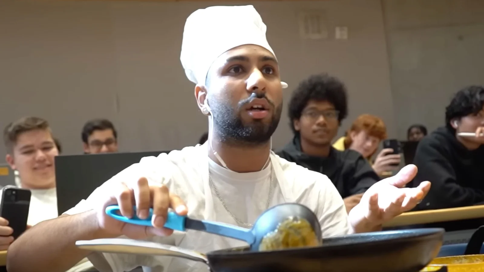 Ding Dong Eat It Up — Person in white head covering eating expressively from blue bowl at kitchen table, the iconic source moment of viral meme.