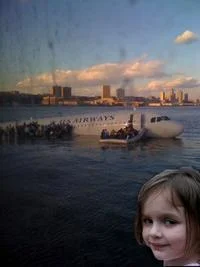 Disaster Girl edited into historical black-and-white nuclear mushroom cloud detonation photograph.