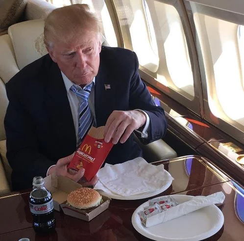 Donald Trump's McDonald's Meal — Donald Trump eating a McDonald's Big Mac and fries on his private plane
