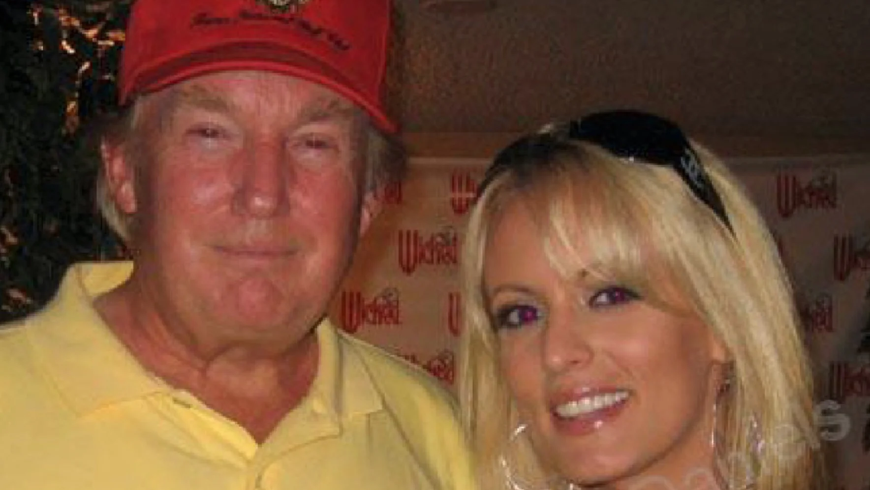 Donald Trump Stormy Daniels Affairs Allegations — Donald Trump in red cap posing with Stormy Daniels at Wicked Pictures event