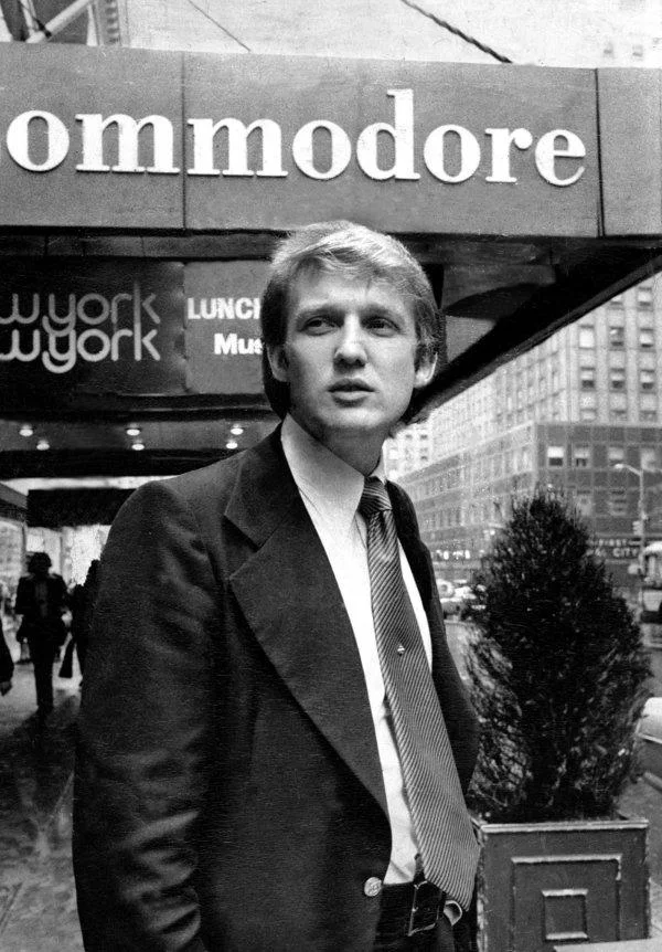 Donald Trumps Hair — Young Donald Trump in suit standing outside the Commodore Hotel in New York