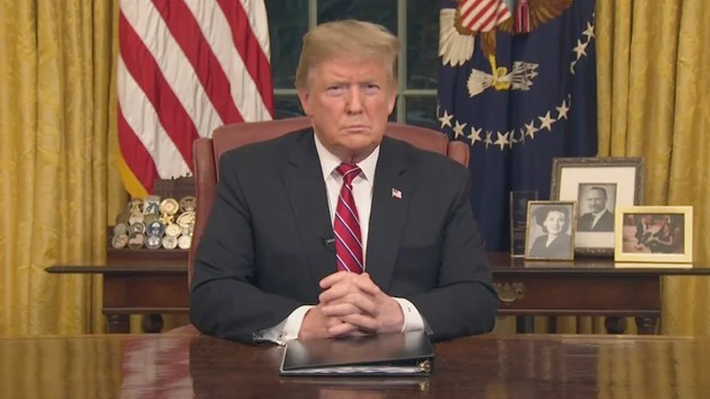 Donald Trumps Prime Time Immigration Address — Donald Trump seated at Oval Office desk delivering televised immigration address