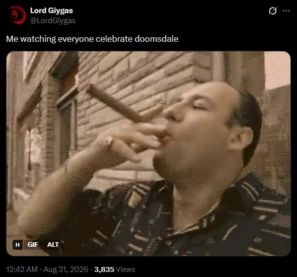 Tweet with GIF of Tony Soprano smoking a cigar, captioned 'Me watching everyone celebrate doomsdale.'