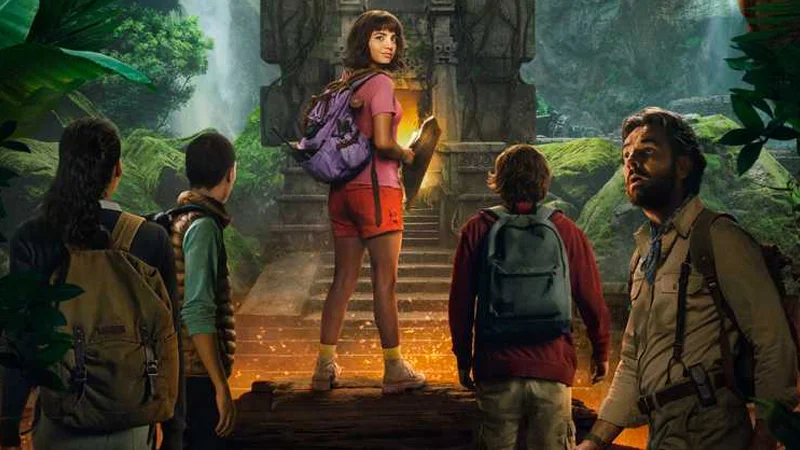Dora And The Lost City Of Gold — Live-action Dora stands atop a stone temple platform surrounded by four companions in a jungle setting.