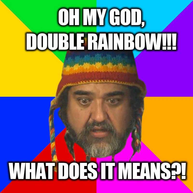 Man from viral video against kaleidoscopic background with text 'OH MY GOD, DOUBLE RAINBOW!!!' and 'WHAT DOES IT MEANS?!'