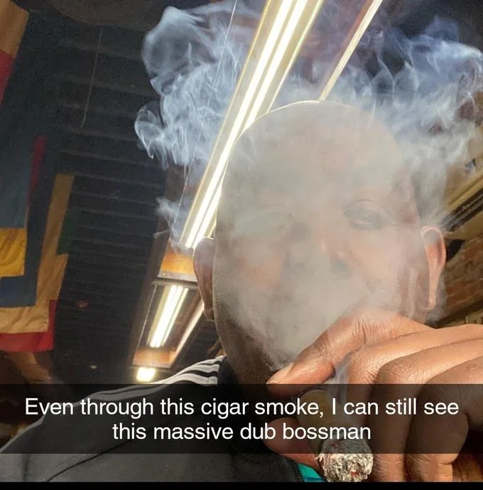 Man obscured by cigar smoke with caption about seeing massive dub bossman