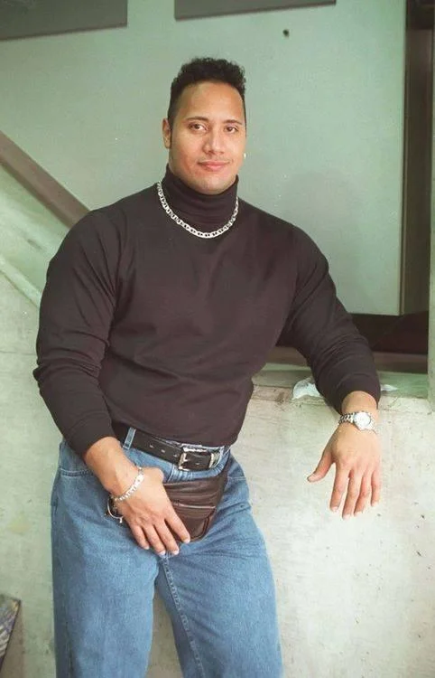 Dwayne The Rock Johnson — Young Dwayne Johnson in black turtleneck, silver chain, jeans and fanny pack