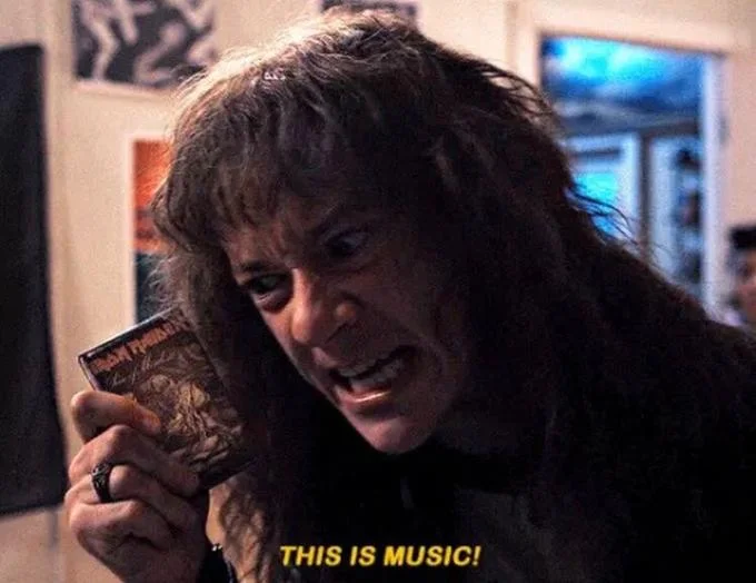 Eddie Munsons This Is Music — Close-up of Eddie Munson holding Iron Maiden cassette with 'THIS IS MUSIC!' caption