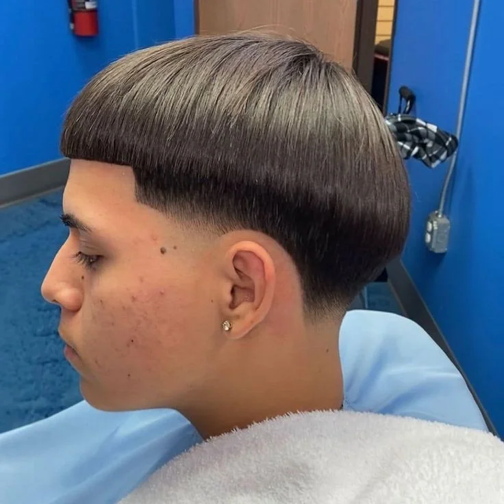 Side profile of young man with classic Edgar haircut in barbershop