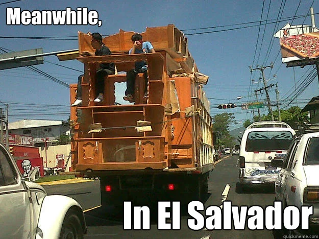 Photograph of run-down modified orange truck on El Salvador street with 'Meanwhile in El Salvador' text.