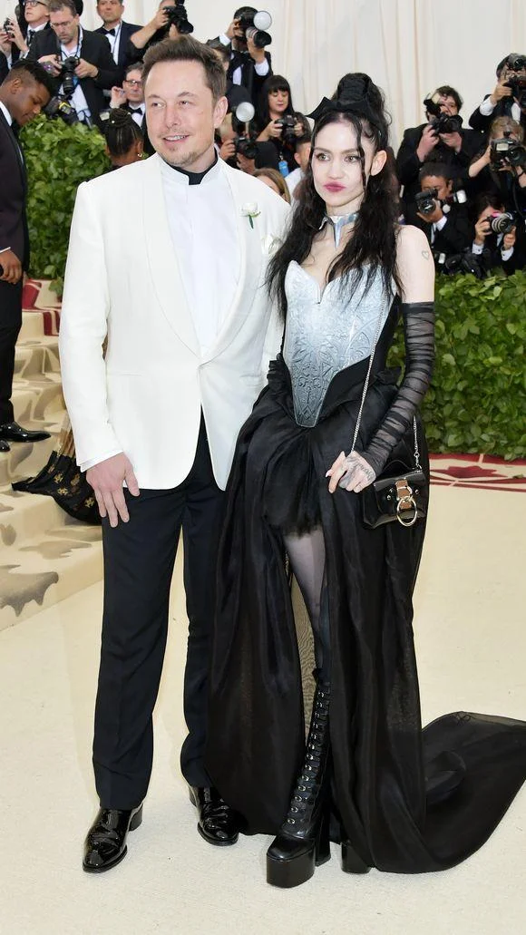 Elon Musk And Grimes Couple Photo Parodies — Full-body Met Gala photo of Elon Musk and Grimes on the red carpet