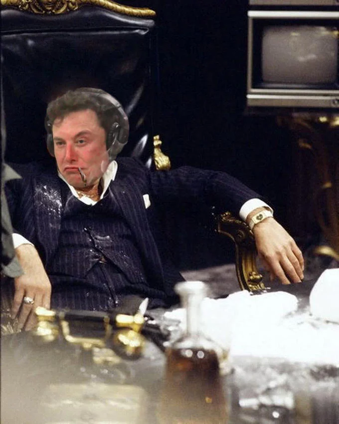 Elon Musk Smoking Weed — Photoshop of Elon Musk as Tony Montana from Scarface at a cocaine-covered desk