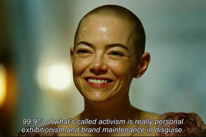 Emma Stone Smiling (Bugonia) — Emma Stone smiling bald in Bugonia with subtitle about activism being personal exhibitionism